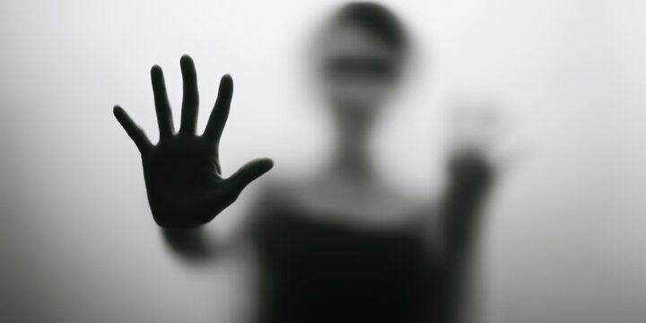 Mystery: silhouette of female hand reaching forward in black and white