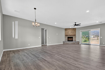 Expansive Living Area With Natural Light, Spacious Lounge Featuring Stone Fireplace And Patio Doors