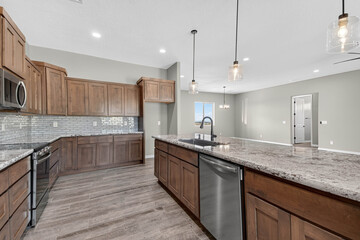 Bright Kitchen With Large Island, Airy Kitchen Space With Stainless Appliances And Hardwood Flooring