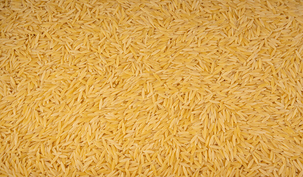 Raw orzo pasta, risoni or kritharaki pile