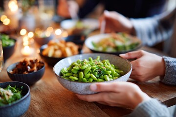 Friends share a warm evening filled with healthy edamame and a variety of plant-based dishes