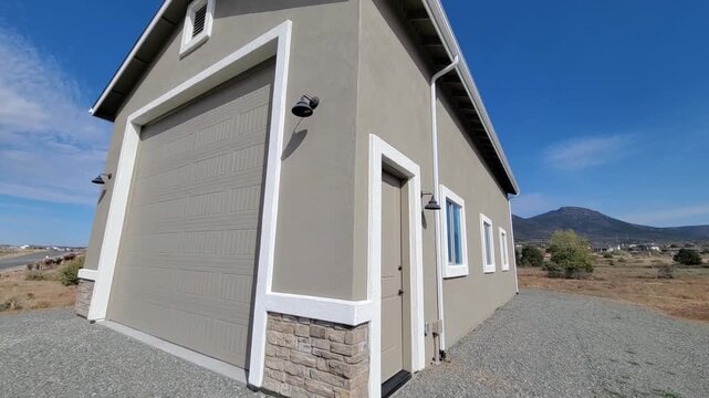 Exterior Of Garage With Yard, Detached Garage Featuring Gravel Driveway And Mountain View Backdrop