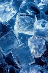 Close up of ice cubes on dark blue background, clear frozen water crystals with cool refreshing atmosphere and detailed texture.