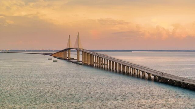 Sunshine Skyway Bridge in Florida, USA at sunset. Driving traffic over Tampa Bay