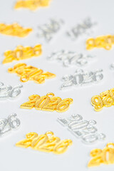 Several necklace pendants made of gold and silver with glittering zirconia, numbers 2026 for the New Year's Eve celebration