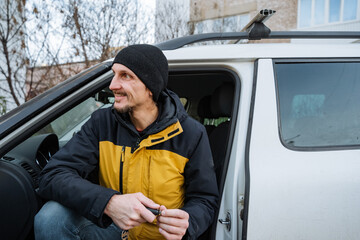 man counting money, individual reviewing currency inside vehicle, man with yellow coat inside suv...