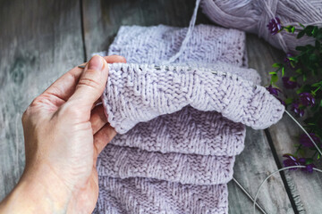 Woman hands knitting needles. knitting a scarf from a variety of wool yarn close-up view from...