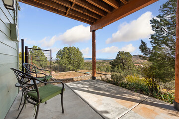 Naklejka premium Charming Mountain Porch, Serene Outdoor Seating With View, Relaxing Porch Area Overlooking Distant Mountains