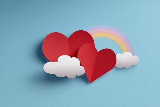Paper hearts and clouds with rainbow on blue background