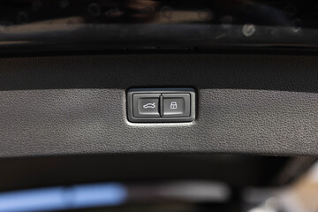 Button for automatic electric opening and closing of trunk door of new passenger car. Automatically opening and closing the trunk. Car trunk lid open button for locking or unlocking
