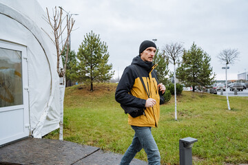 stroll in neighborhood, walking through suburban park, gentle pace exploring nearby outdoor recreational space, man quietly observing natural surroundings along peaceful neighborhood trail