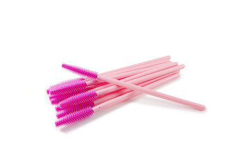 Disposable eyelash brush wands arranged on a white isolated background, professional cosmetic tools used for lash extension, grooming and hygienic makeup application