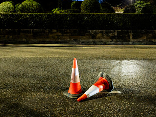 Orange traffic cones, also known as safety cones or pylons at night, Edinburgh, Scotland, United Kingdom