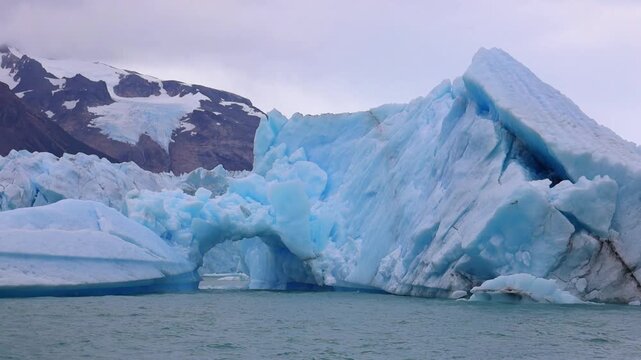 Perito Moreno Glacier in Patagonia showing massive ice wall, turquoise water, frozen textures, rugged wilderness, dramatic landscape, natural environment, climate scenery majestic travel area backdrop