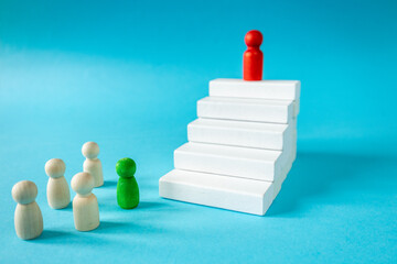 Achieving success. Stages of development. The leader of the organization at the top. White stairs leading up. The path to achieving the goal. Business concept. close up. copy space. Blue background