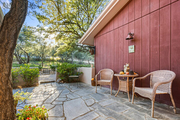 Obraz premium Secluded Patio With Vibrant Greenery, Private Garden Area With Relaxing Seating And Colorful Plants