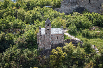 Historic Stone Chapel Surrounded by Green Forest Landscape