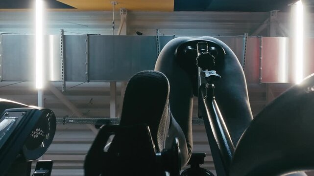 Woman Viewed From Below Trains On A Pedal Exerciser In The Gym