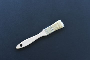 Small flat paintbrush with wooden handle