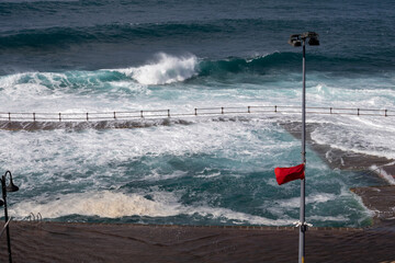 Red flag on the Atlantic ocean beach, Tenerife, Spain
