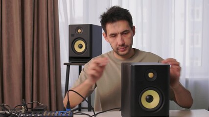 Home studio sound system adjustment, Decking speaker connections in recording space, Carefully connecting audio cables and calibrating sound levels in personal music studio - Powered by Adobe