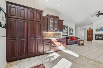 Bright Kitchen With Ample Storage, Spacious Culinary Area Featuring Bold Cabinets And Sunlit Tiles