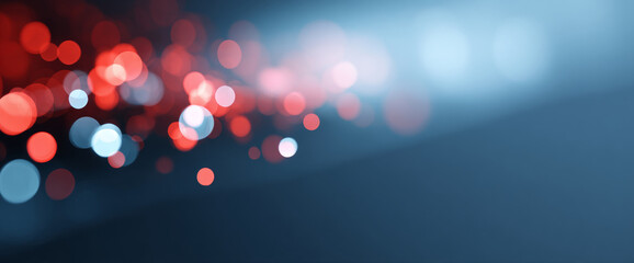 Abstract bokeh background with red and blue circular light spots on a dark gradient surface, creating a soft and blurred visual effect