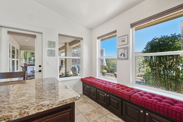 Inviting Sundrenched Kitchen Nook Furnished With Comfortable Cushions Overlooking Picturesque Garden Scene