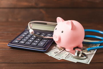 Medical costs, financial concept, health insurance. Stethoscope over dollar bills. Money and piggy bank. Medical care. Health care financial checkup or saving for medical insurance costs concept.