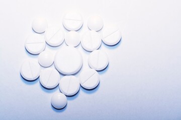 white pills on white background