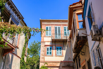 Historic mediterranean architecture with blue shutters under clear blue sky