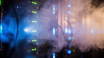 Server racks emitting smoke in a data center. Data storage and information technology concept for computer network infrastructure.