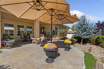 Outdoor Gathering Space, Patio With Furniture And Plants, Spacious Outdoor Area With Seating And Decorations