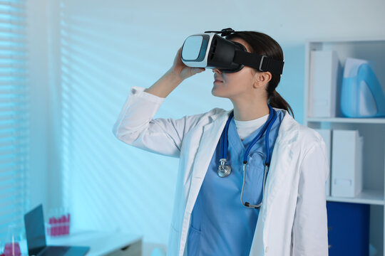 Modern technology. Doctor using virtual reality headset in office - Powered by Adobe