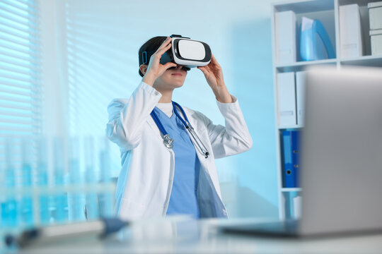 Modern technology. Doctor using virtual reality headset in office