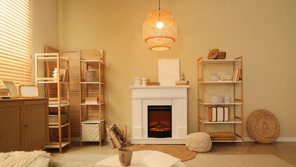 Fototapeta premium Interior of cozy living room with fireplace, shelving units and lamp
