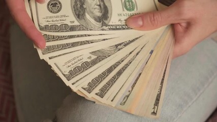 Close-up female entrepreneur counting cash money in hands. Wealthy people a pro businesswoman, salary dollars winner, prize income. Business assets, freelance work, or illegal acts - Powered by Adobe