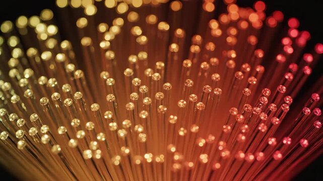 Optical fiber ends glowing with warm light create fascinating display. Optical fiber network cables shine, showing advanced technology and communication links.