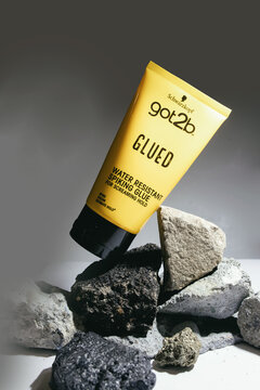 12.-1.2025, Zory, Poland, Got2b styling product placed on natural stones, editorial image showing branded hair styling glue in a creative composition highlighting strong hold and product identity