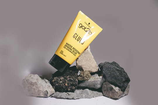 12.-1.2025, Zory, Poland, Got2b styling product placed on natural stones, editorial image showing branded hair styling glue in a creative composition highlighting strong hold and product identity