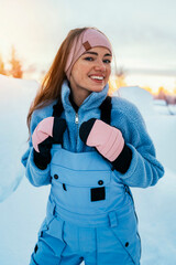 Beautiful caucasian women posing in winter sports clothing during sunset in Lapland