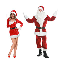 Man and woman in Santa costumes on white background. Merry Christmas and Happy winter holidays