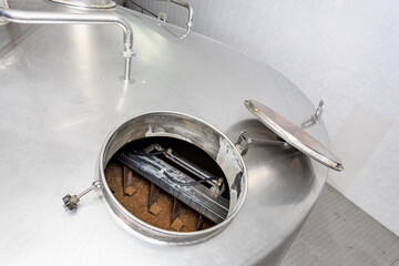 Stainless steel brewery tank with open lid for fermentation process