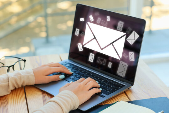 Email notification. Teenage girl using laptop at table, closeup. Letters on computer screen