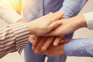 Group of volunteers stacking hands, closeup. Charity, support, teamwork