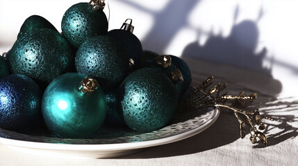 Christmas ornaments on a plate in sunlight creating festive shadows for concept of holiday decor and winter celebration
