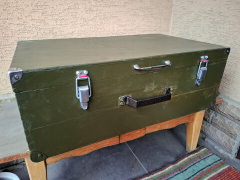 An old green wooden chest with two handles