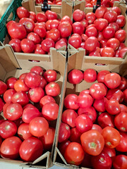 Red tomatoes in cardboard boxes at grocery store