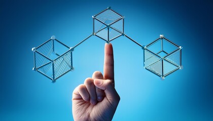 a finger balancing a wire cube connected to other cubes against a blue gradient background