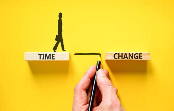 Time change symbol. Concept word Time change on beautiful wooden blocks. Beautiful yellow paper background. Businesswoman icon. Business time change concept. Copy space.